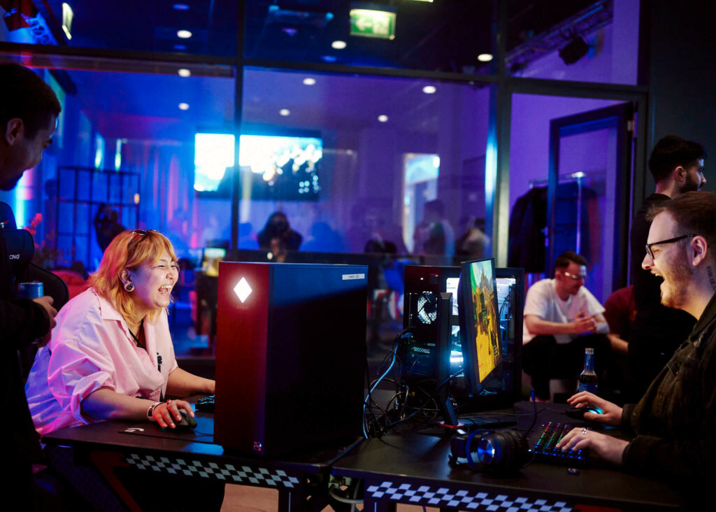 XPERION NXT Announcement Event - people play games on Computers and have a smile on their face